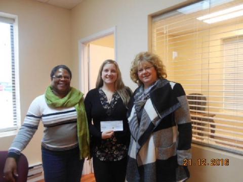 Jo Ann Wells, President of the Gande Area Council presents cheque to Status of Women Council