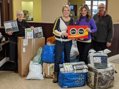  Charline Gautreau and Isabelle Forest from the PSAC Greater Moncton Area Council presenting the articles to the House of Nazareth responsibles